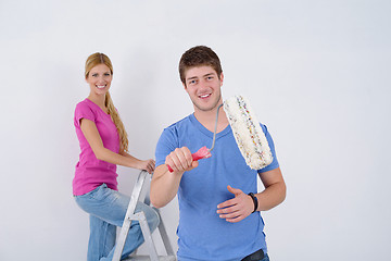 Image showing happy couple paint wall at new home