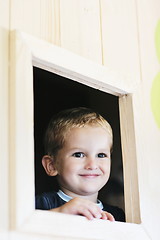 Image showing happy child in a window