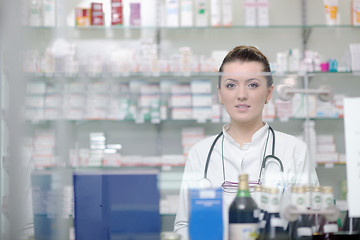 Image showing pharmacist chemist woman standing in pharmacy drugstore