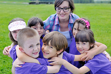 Image showing happy kids group with teacher in nature