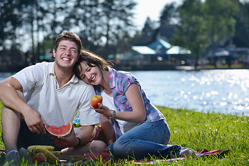 Image showing happy young couple having a picnic outdoor