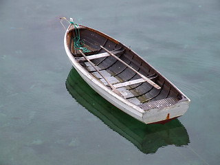 Image showing Old fishing boat on still water