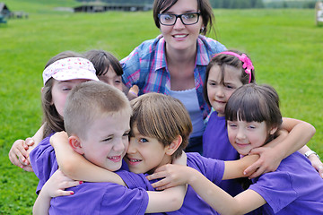 Image showing happy kids group with teacher in nature