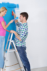 Image showing happy couple paint wall at new home