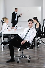 Image showing Portrait of a handsome young business man with colleagues in bac