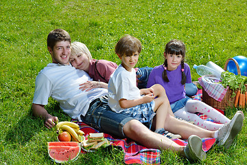 Image showing Happy family playing together in a picnic outdoors