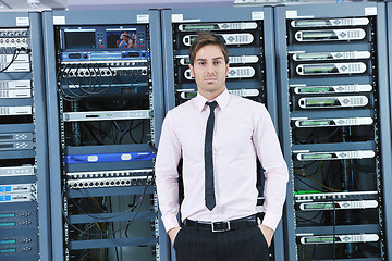 Image showing young it engeneer in datacenter server room