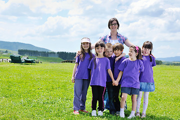 Image showing happy kids group with teacher in nature