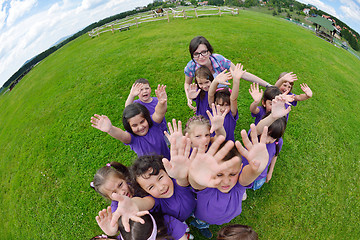 Image showing happy kids group with teacher in nature