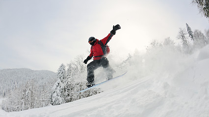 Image showing snowboarder on fresh deep snow