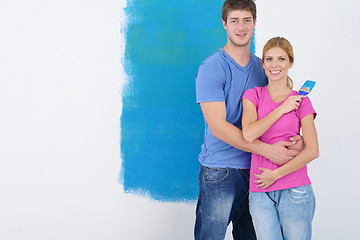 Image showing happy couple paint wall at new home