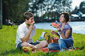 Image showing happy young couple having a picnic outdoor