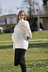 Image showing happy young pregnant woman outdoor