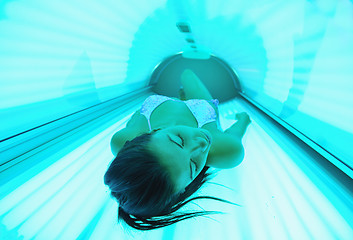 Image showing Beautiful young woman tanning in solarium