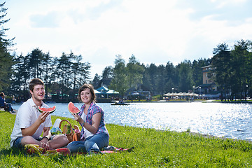 Image showing happy young couple having a picnic outdoor