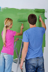 Image showing happy couple paint wall at new home