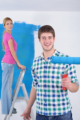 Image showing happy couple paint wall at new home