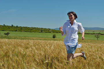 Image showing young woman in wheat field at summer