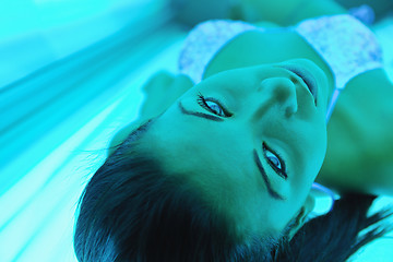 Image showing Beautiful young woman tanning in solarium