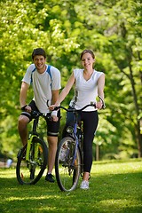 Image showing Happy couple riding bicycle outdoors