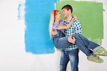 Image showing happy couple paint wall at new home