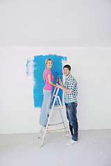 Image showing happy couple paint wall at new home