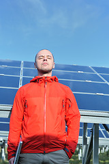 Image showing engineer using laptop at solar panels plant field