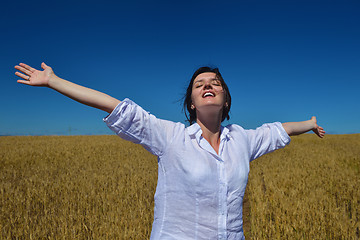 Image showing young woman in wheat field at summer