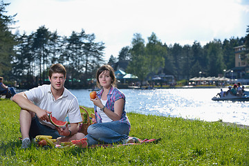 Image showing happy young couple having a picnic outdoor