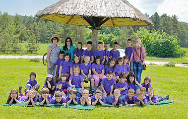 Image showing happy kids group with teacher in nature