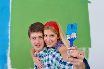 Image showing happy couple paint wall at new home