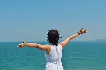 Image showing happy young woman with spreading arms to sky