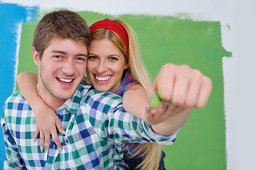 Image showing happy couple paint wall at new home