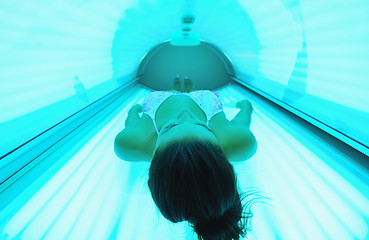 Image showing Beautiful young woman tanning in solarium