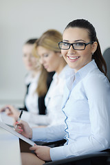 Image showing business woman standing with her staff in background