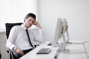 Image showing tired and depresed young business man at office