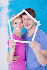 Image showing happy couple paint wall at new home