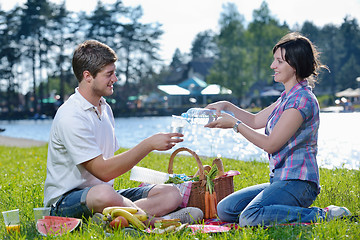 Image showing happy young couple having a picnic outdoor