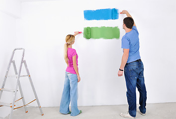 Image showing happy couple paint wall at new home