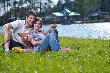 Image showing happy young couple having a picnic outdoor