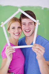 Image showing happy couple paint wall at new home