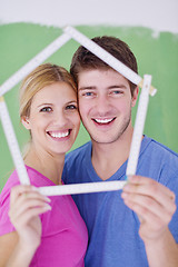 Image showing happy couple paint wall at new home