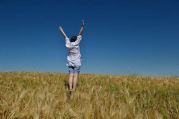 Image showing young woman in wheat field at summer