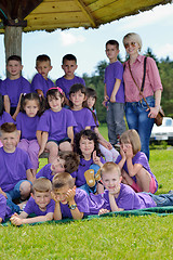 Image showing happy kids group with teacher in nature