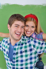 Image showing happy couple paint wall at new home