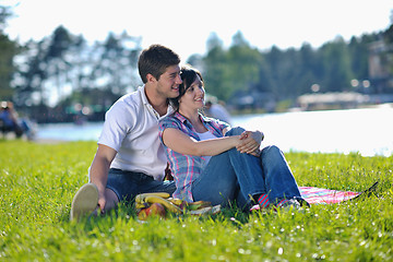 Image showing happy young couple having a picnic outdoor