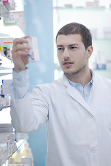 Image showing pharmacist chemist man in pharmacy drugstore