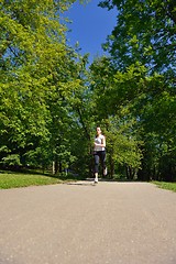 Image showing Young beautiful  woman jogging at morning in park