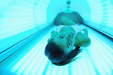 Image showing Beautiful young woman tanning in solarium