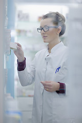 Image showing pharmacist chemist woman standing in pharmacy drugstore